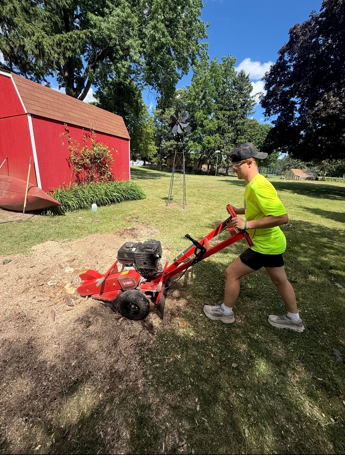 Traub crew member stump grinding on a residential property